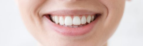 Cute girl showing her awesome joyful smile and white teeth Close up shot of young beautiful woman toothy smile